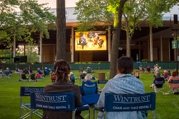 couple sitting in blue wintrust rental chairs from ravinia