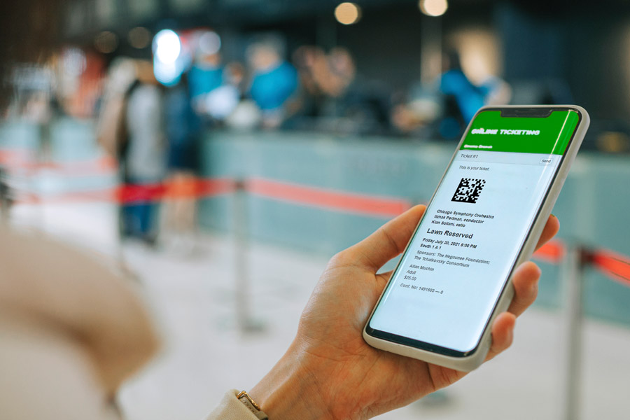 woman holding phone with ticket