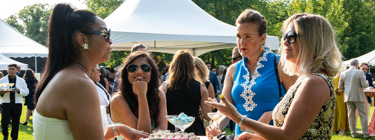 Ravinia Women’s Board members and guests socializing at the Gala Benefit Evening fundraising event